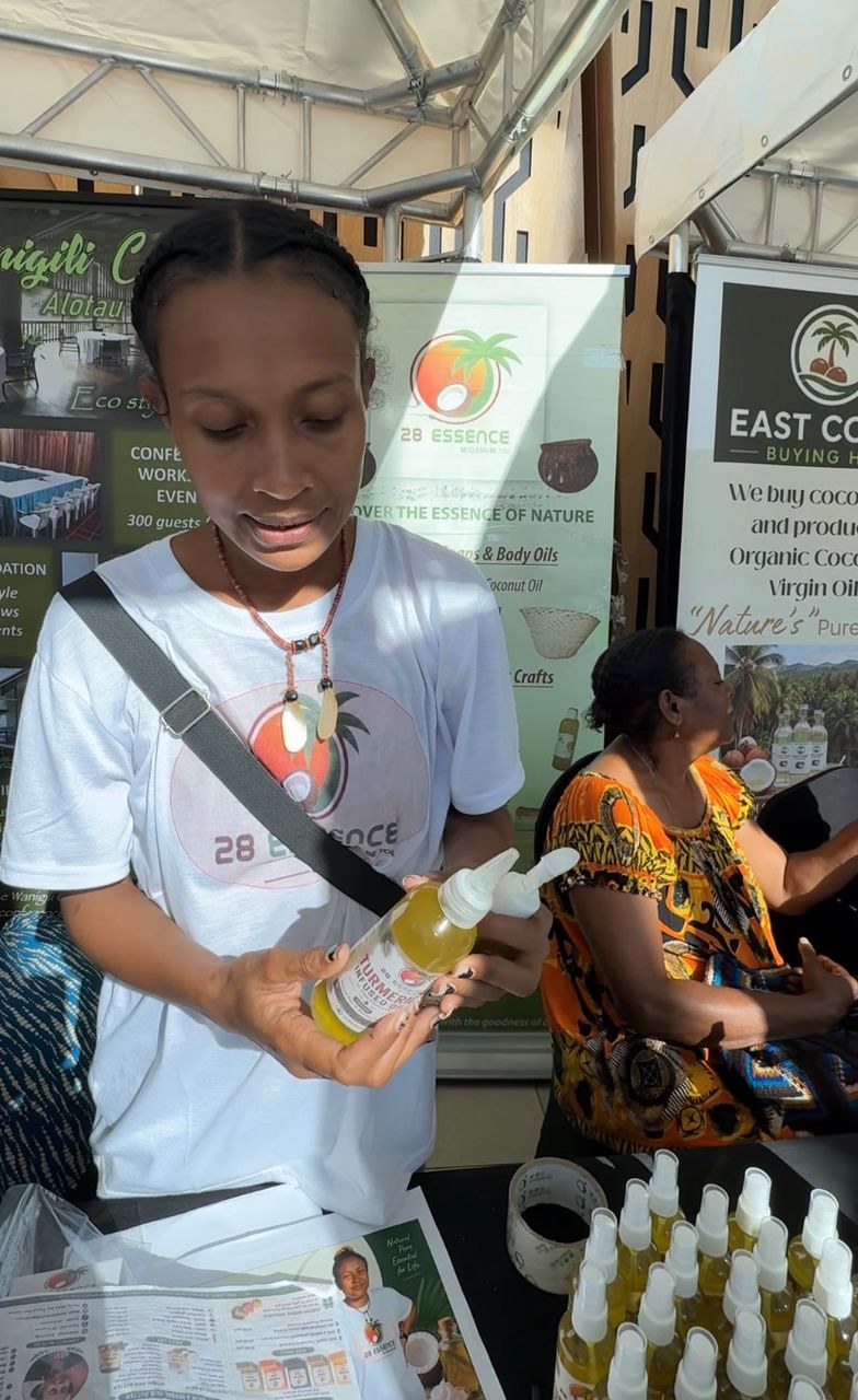 28 Essence sales representative Kimberly Maraga demonstrating products at the PNG SME Week Agritrade Expo in June 2026.