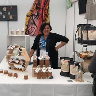 Rhona Conn beside a display of Milne Bay Organics products