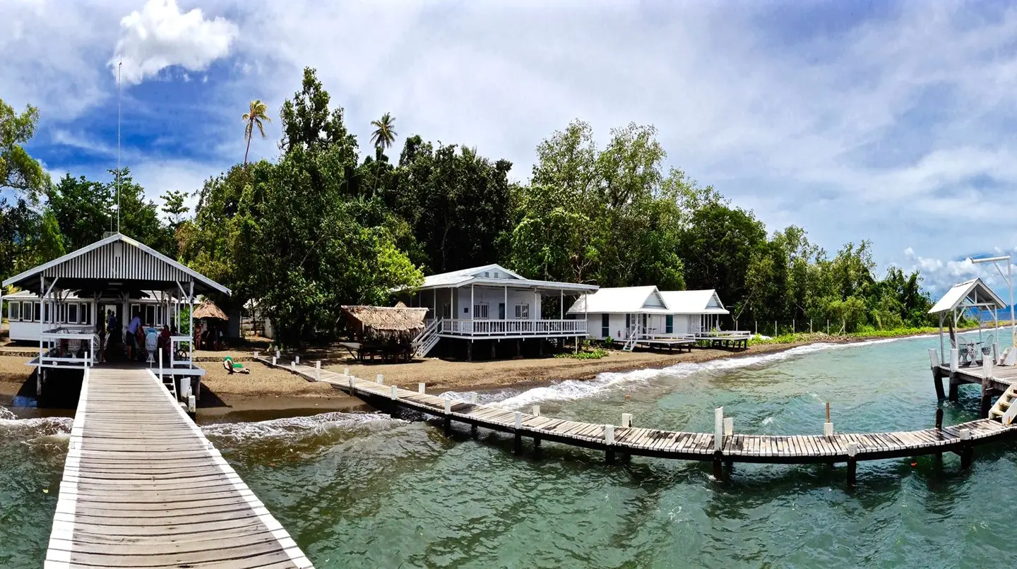 Waterfront walkway and bungalows at Driftwood Resort Alotau