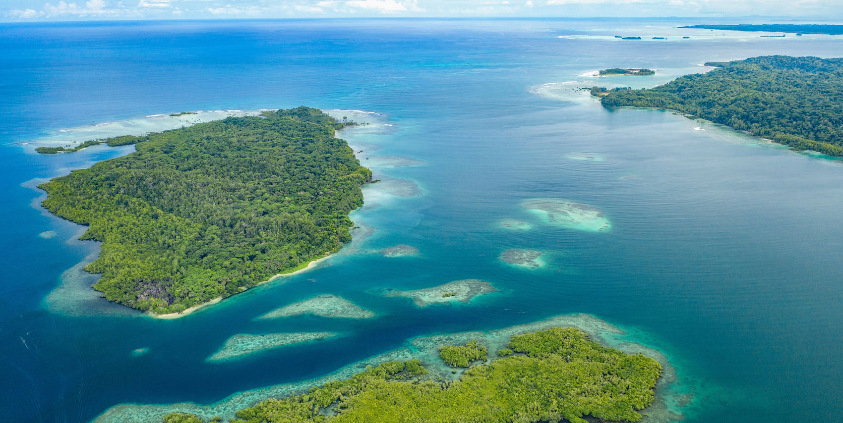 Reef lagoons and forested islands of Milne Bay — fallback photograph via Princess Cruises