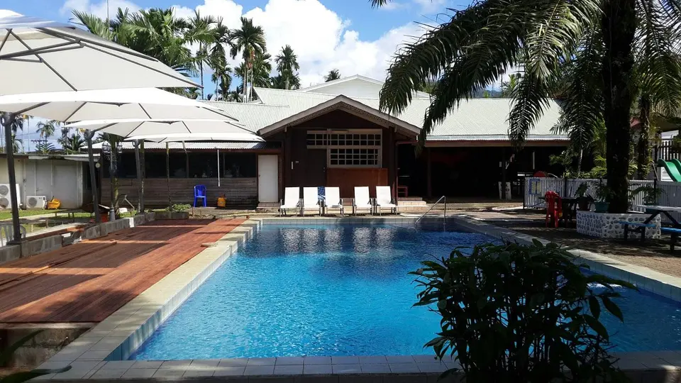 Pool, deck and tropical gardens at Masurina Lodge