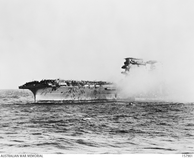 USS Lexington burning while members of the crew abandon ship during the Battle of the Coral Sea.